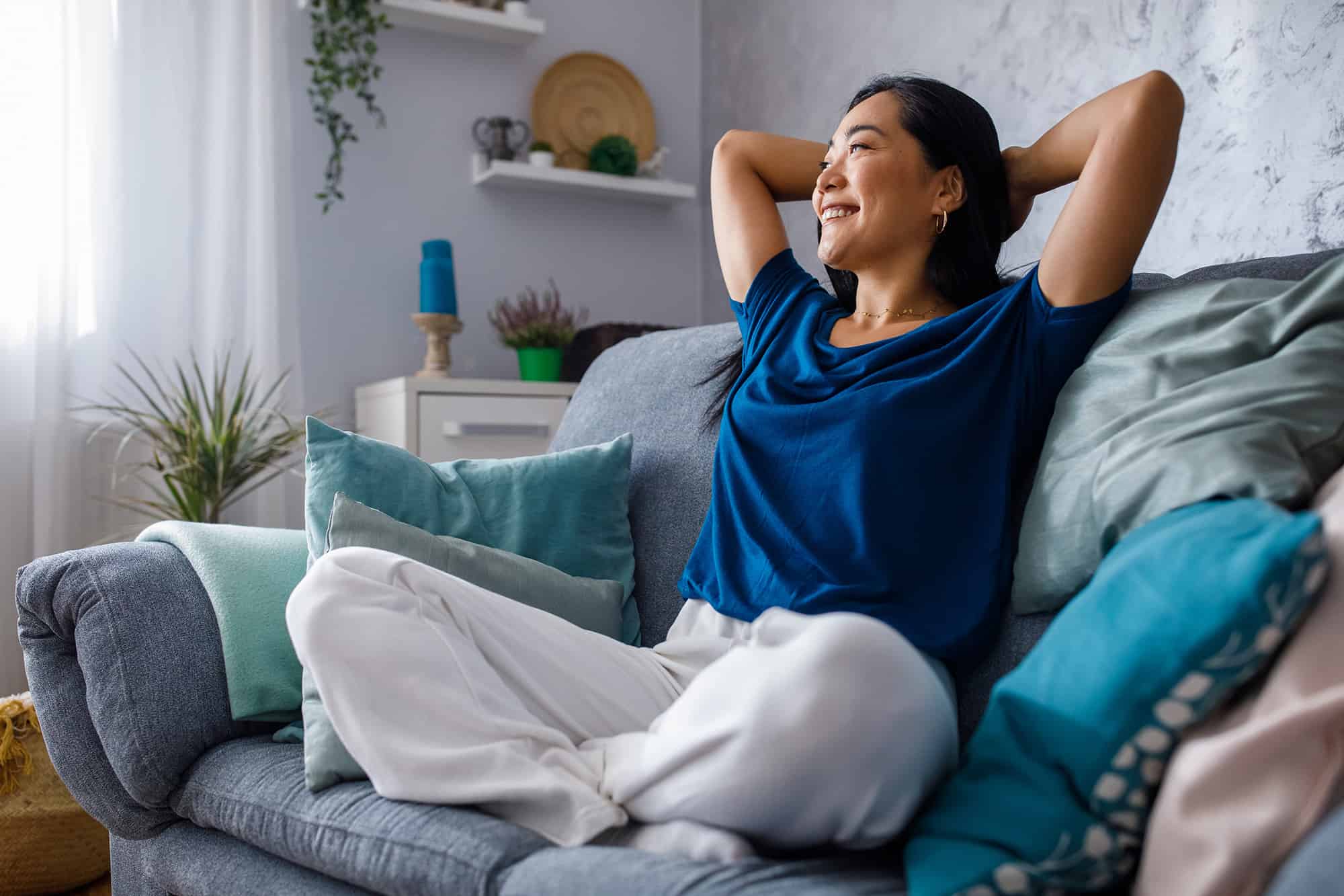 young woman lounging on sofa